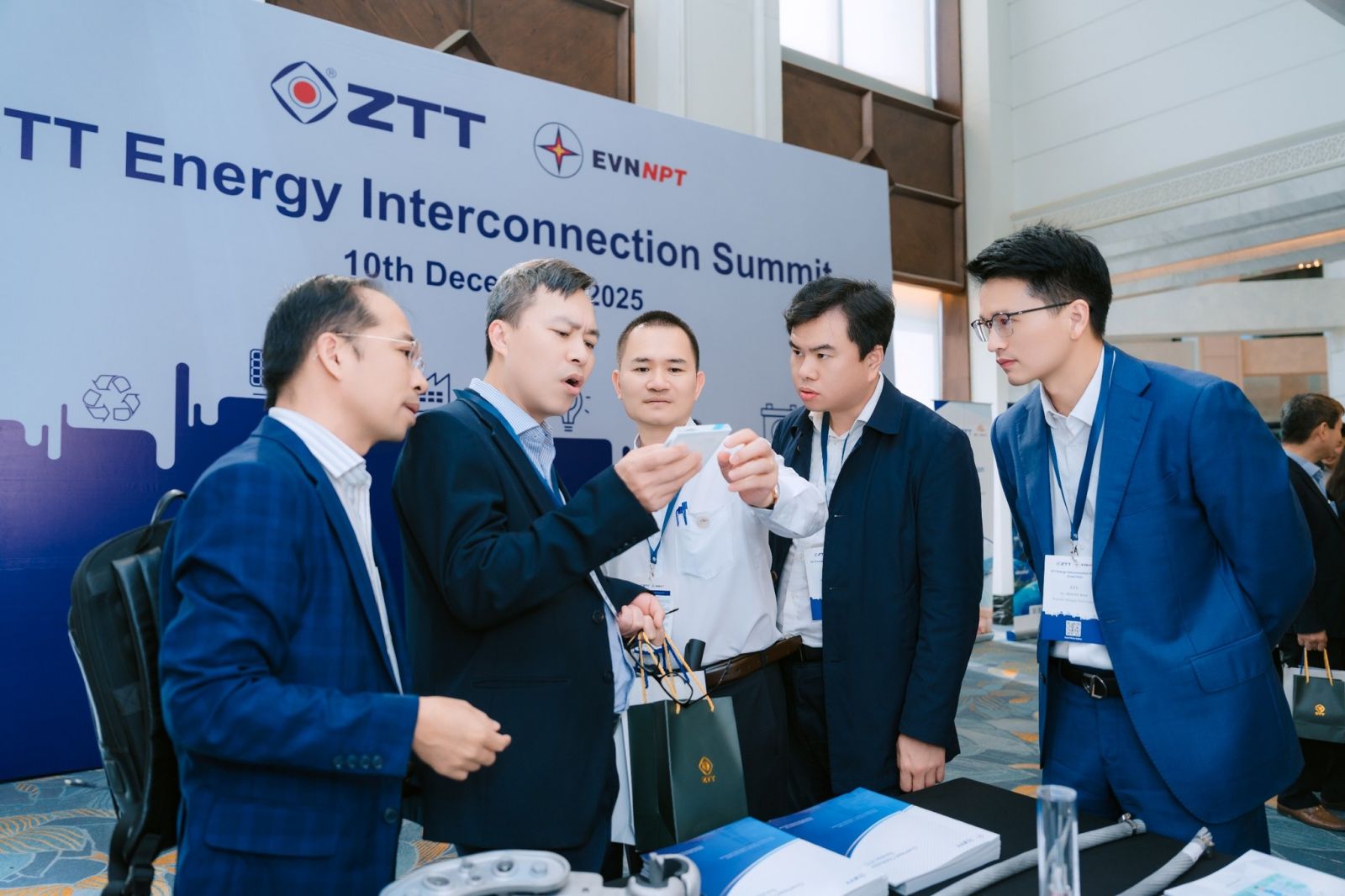 A group of men standing around a tableAI-generated content may be incorrect.